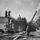 American troops of the 35th Coast Artillery firing 1,200 pound shells from an enormous 14 inch railway mounted gun at the opening of the Meuse-Argonne Offensive during World War I.